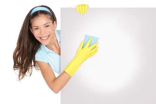Carpet cleaner wearing protective gloves during treatment